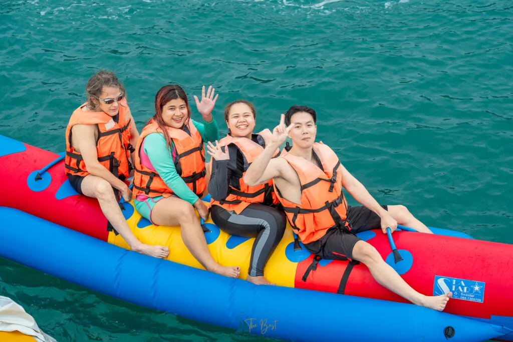 Group enjoying banana boat ride at sea.